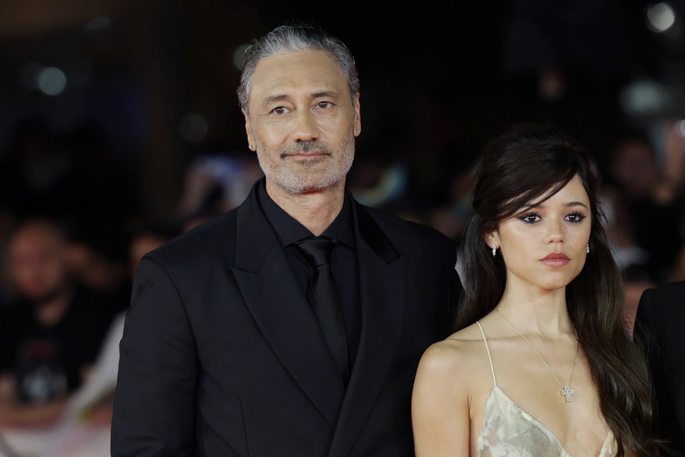 Taika Waititi, left, is promoting Klara and the Sun, starring Jenna Ortega, right, his film adaptation of the 2021 novel by Kazuo Ishiguro (Getty)