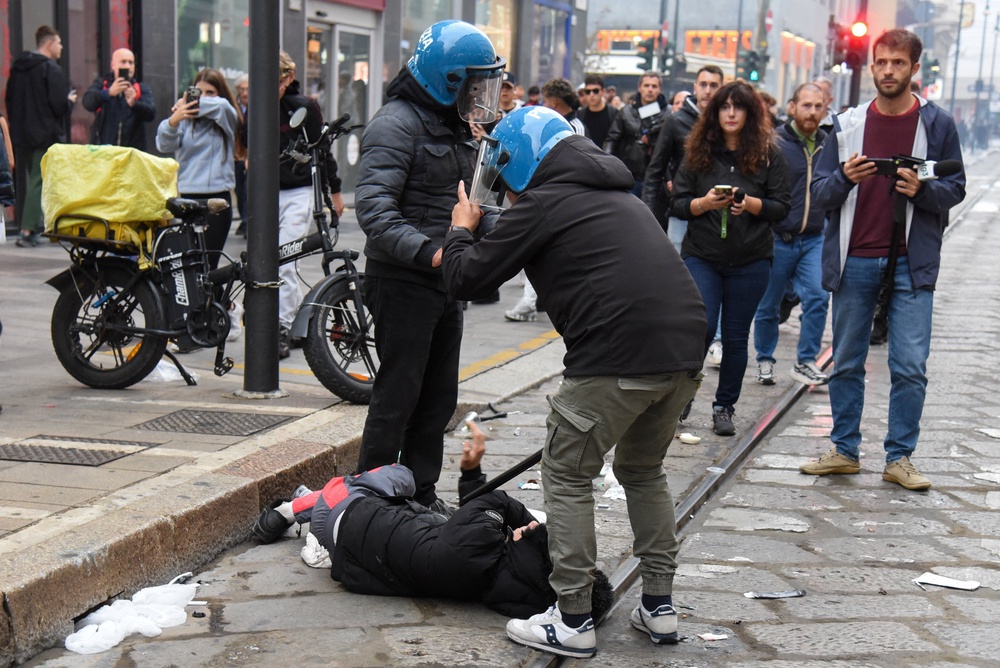 Italian police detain a protester during a protest over the state of public services and the rising cost of living in Milan (Reuters)
