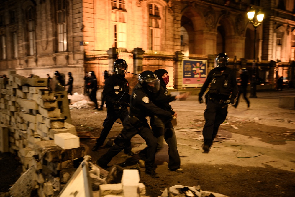 Police officers push a demonstrator at the Place de la Comedie in Lyon (AFP/Getty)