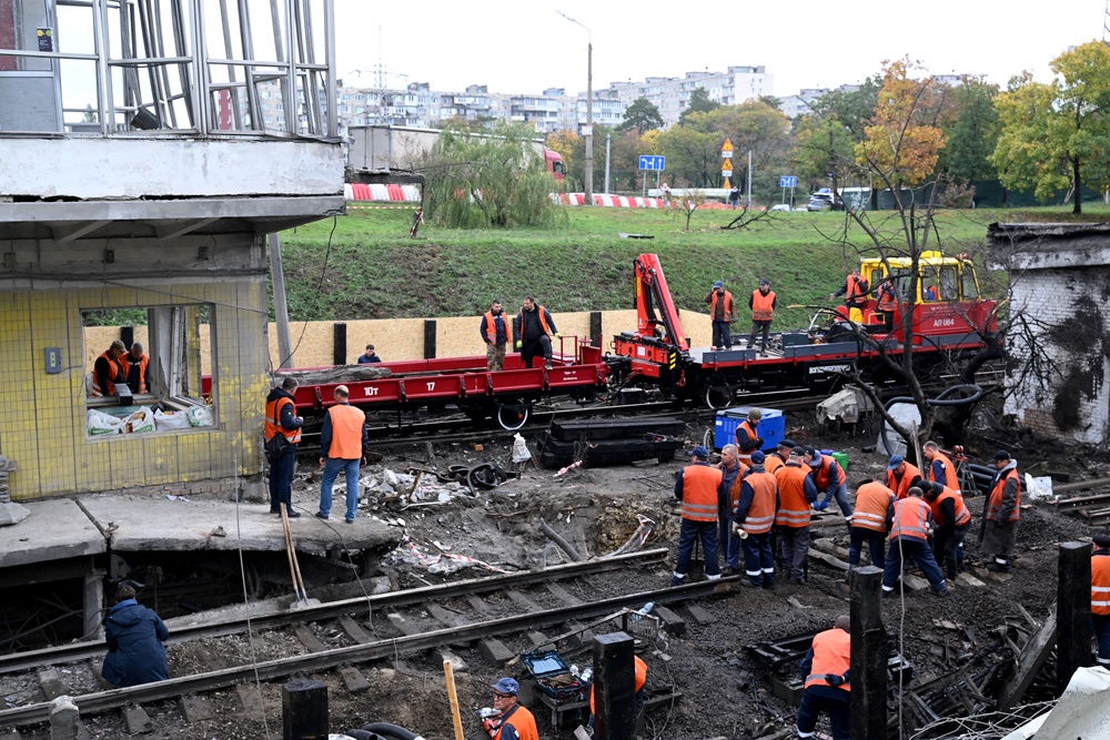 Workers clear the rubble from a metro station following a Russian ballistic missile strike on Kyiv on 19 October 2026 (AFP/Getty)