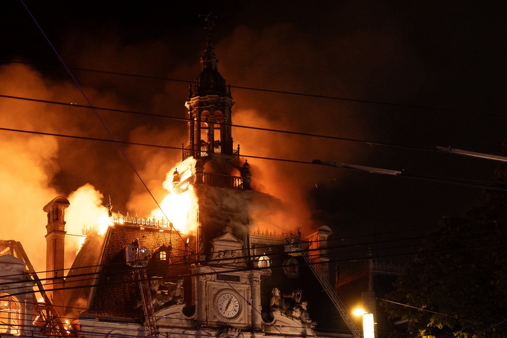 The clocktower of the Limoges town hall burns after rioters set the historic building alight (AFP/Getty)