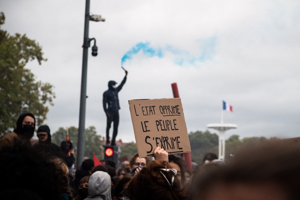 'The state oppressed, the people speak out', reads a placard in Lyon on Sunday (AFP/Getty)