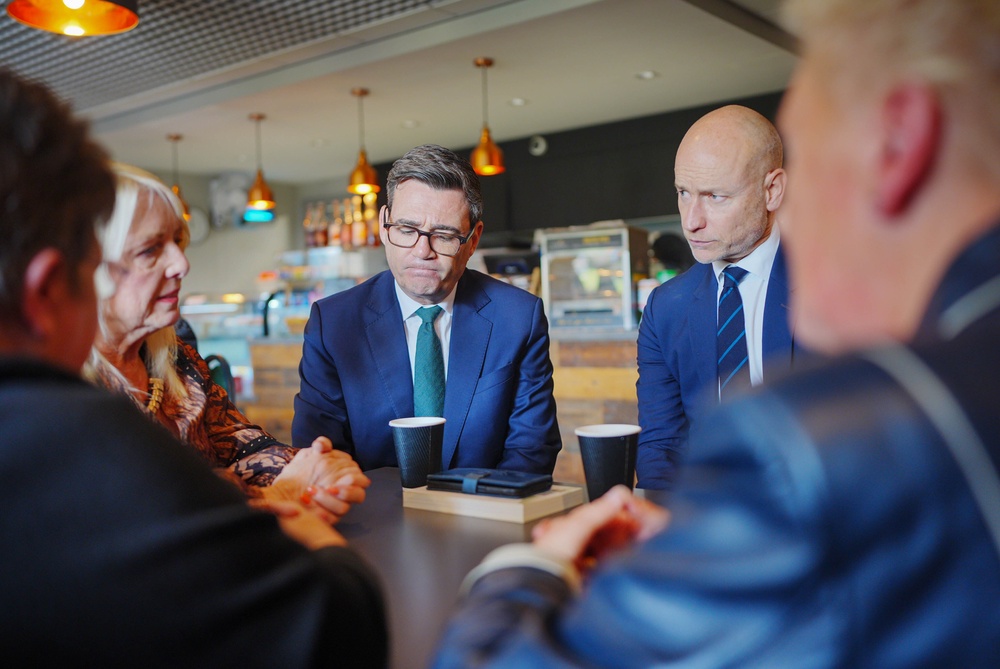 Prime Minister Andy Burnham (centre left) and Welsh Secretary Stephen Kinnock (centre right) talking to locals at Aberfan community centre (Ben Birchall/PA) (PA Wire)