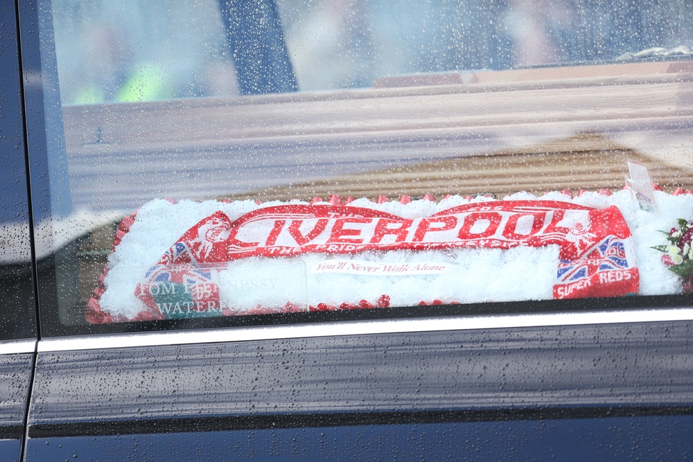 A Liverpool FC scarf is visible in one of the hearses (Evan Treacy/PA) (PA Wire)