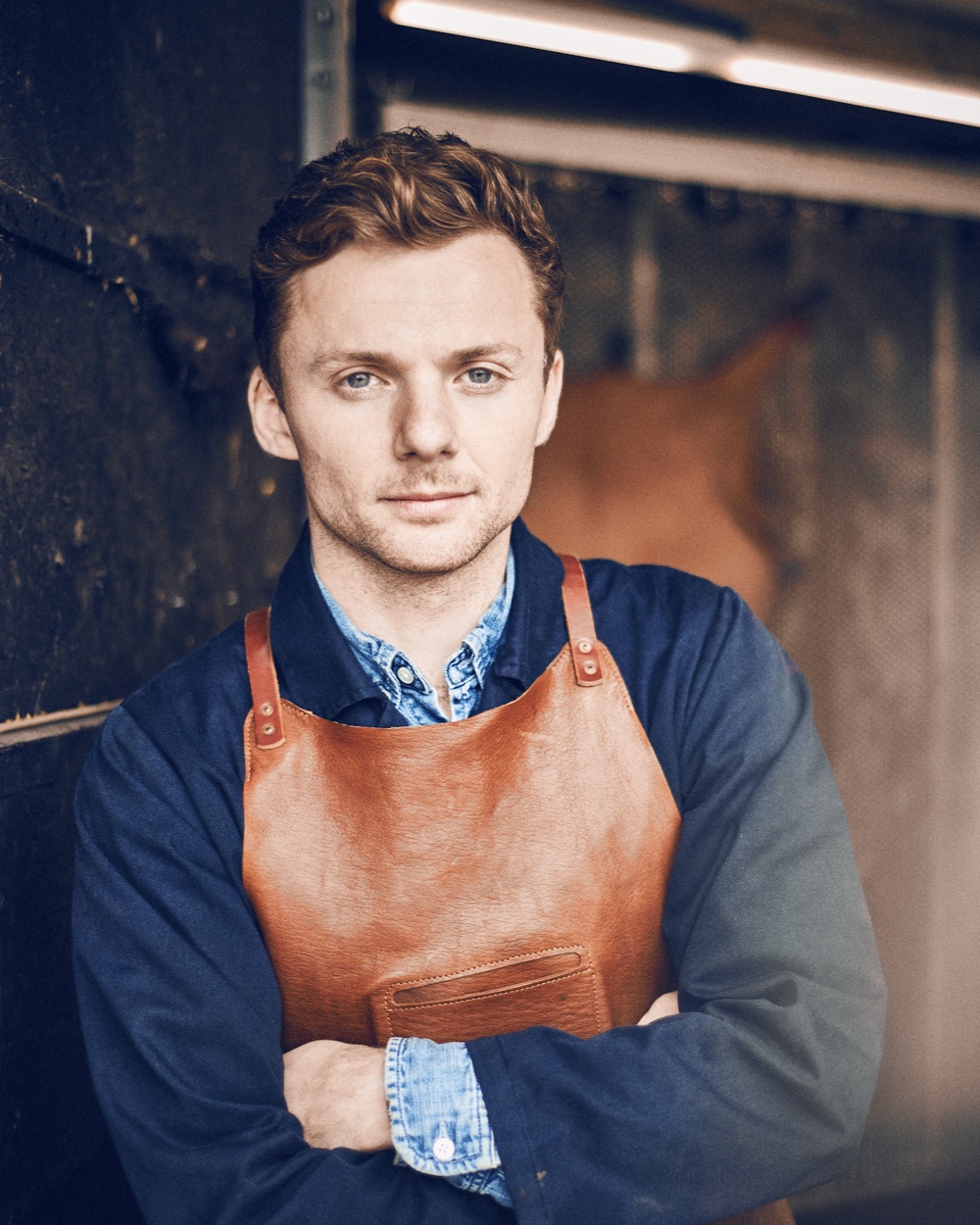 Jack Millington, co-founder of Billy Tannery, wearing one of the company’s goatskin aprons, originally designed with OTZI (Billy Tannery)