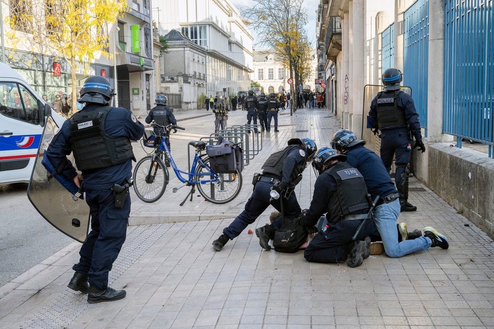 Several French police officers in riot gear pin a protester to the ground during an arrest at a demonstration against the rising cost of living and social inequalities in Poitiers, Vienne, Nouvelle-Aquitaine (AFP/Getty)