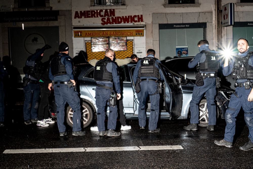 Police stop a vehicle entering the curfew zone after 9 pm on Rue de la Barre, just before Place Bellecour in Lyon (AFP/Getty)