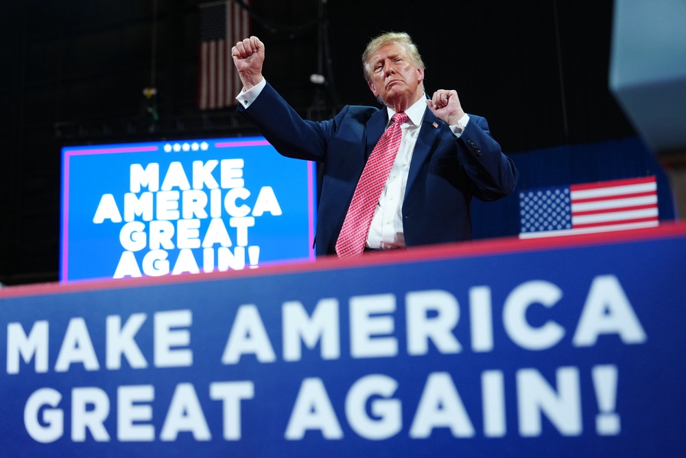President Donald Trump dances at a campaign rally in Park City, Kansas (AP)