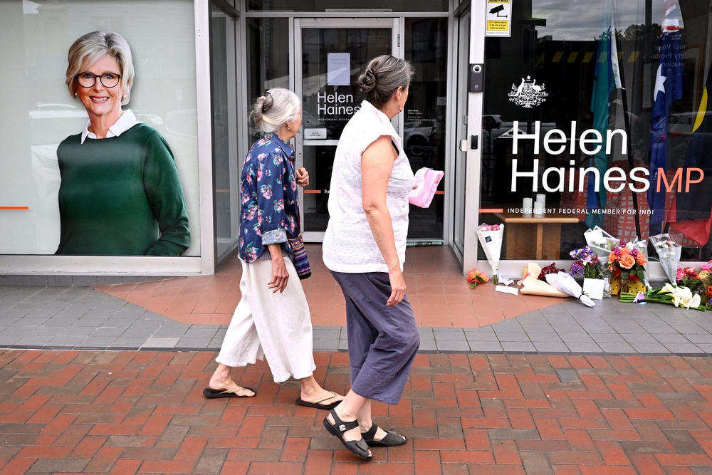 People lay flowers outside the office of Australian politician Helen Haines in the northern regional city of Wangaratta (AFP/Getty)