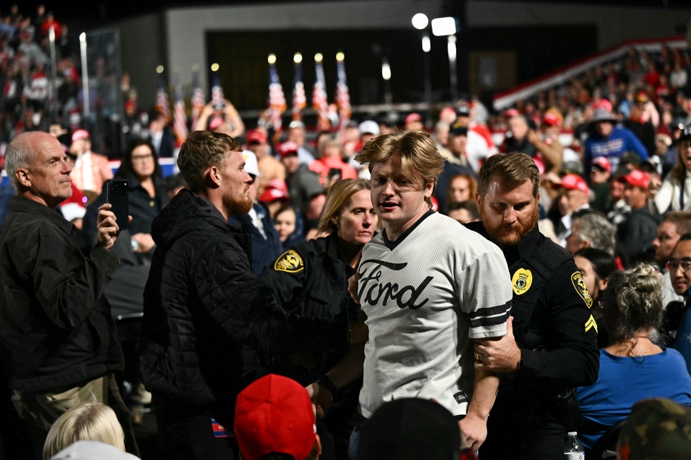 'They get paid by the radical left lunatics that you watch taking place in France,' Trump said Tuesday night. 'I would say this is a slightly lesser event,' he then admitted. (AFP via Getty Images)