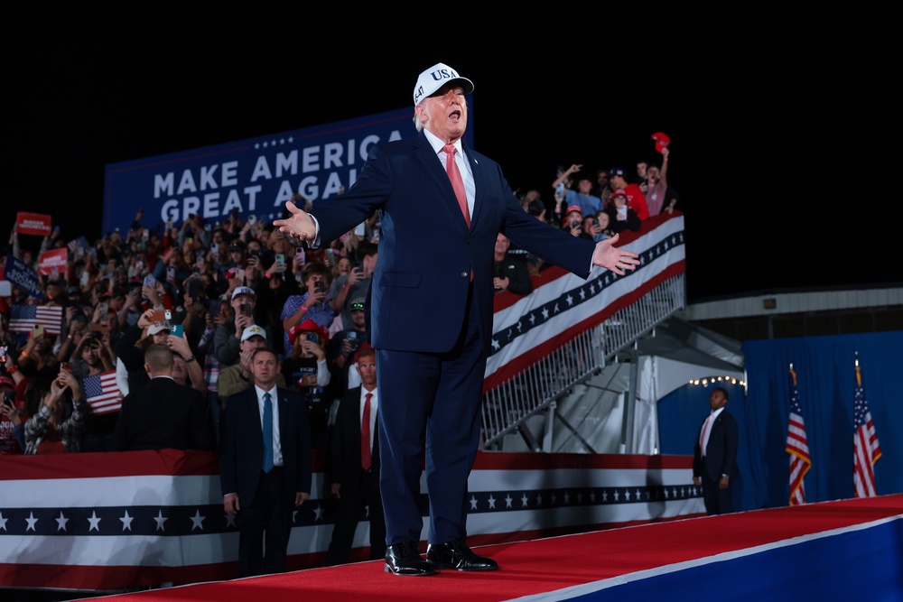 During another disruption later that night, Trump said, 'Don’t hurt them,' but then mimicked wanting to punch them — a callback to his first presidential campaign in 2016 when he encouraged his supporters in Iowa to 'knock the crap out of' anyone preparing to throw tomatoes (Getty Images)