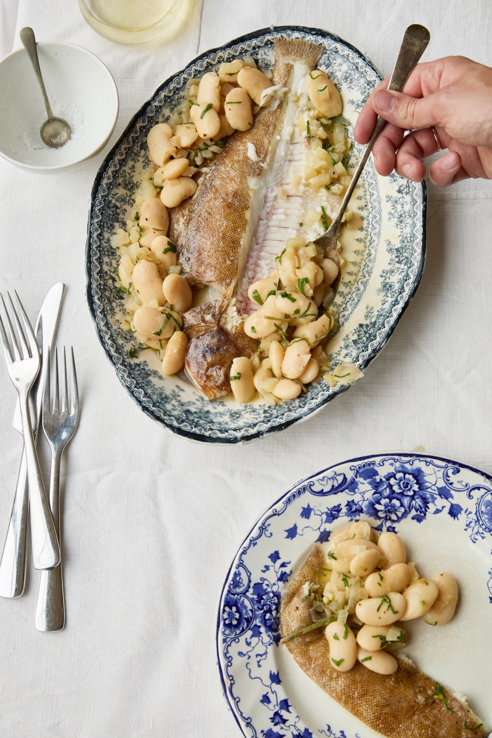 Delicate lemon sole meets creamy butter beans in a simple dish that makes the most of the whole fish (Helen Cathcart)