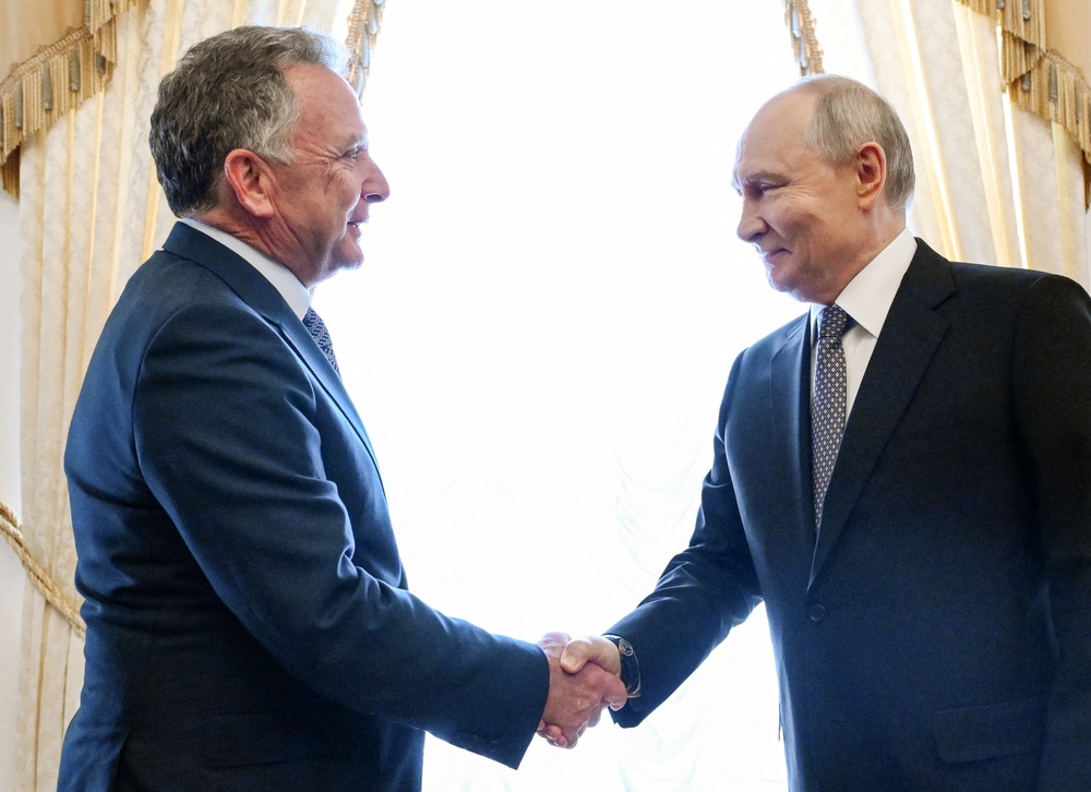 Russian president Vladimir Putin shakes hands with US special envoy Steve Witkoff during a meeting at the Constantine Palace in St Petersburg (Reuters)