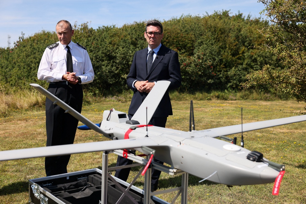 Prime Minister Andy Burnham talks with Duncan Capps, Border Security Commander (DG BSC) as he is shown a surveillance drone, during a visit to HM Coastguard Maritime Rescue Coordination Centre, in Dover, southern England,  on August 2, 2026. (AFP/Getty)