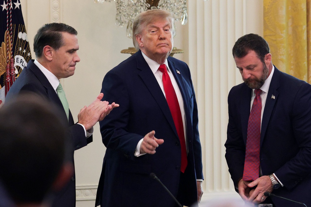 U.S. President Donald Trump (C) gestures as he departs with U.S. Attorney General Todd Blanche (L) and U.S. Secretary of Homeland Security Markwayne Mullin following a roundtable discussion on cybercrime in the East Room of the White House (Getty)
