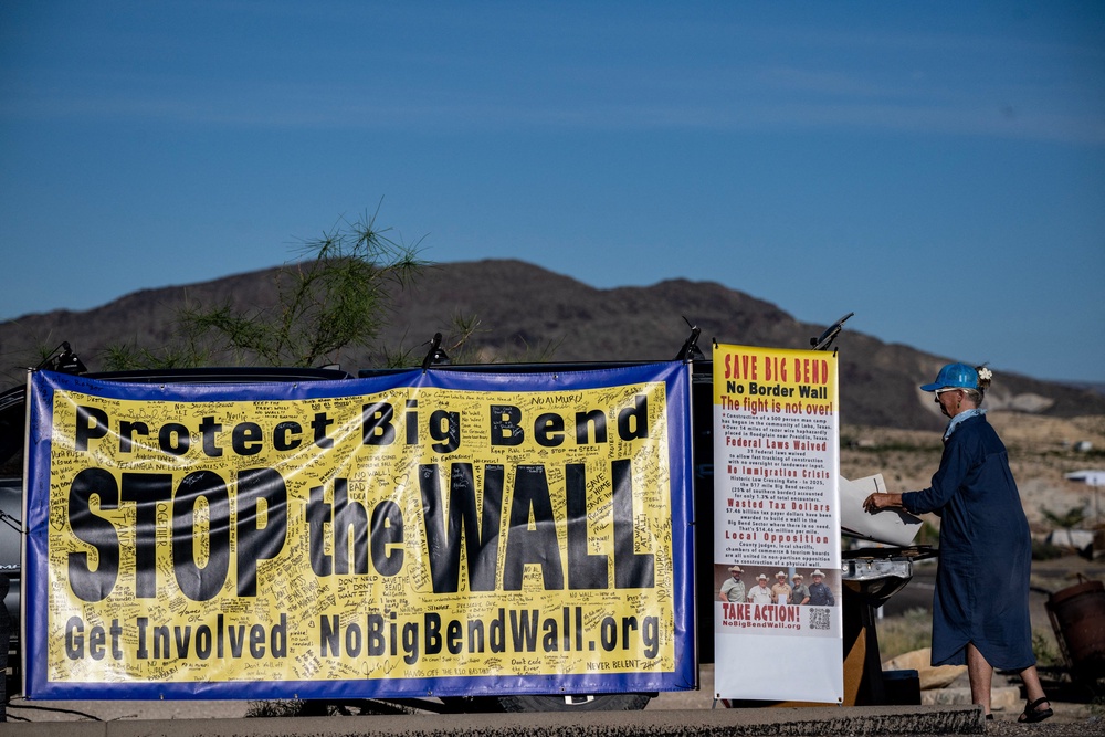 A woman protests the plans by US President Donald Trump's administration to build a section of the border wall at the Big Bend National Park in Study Butte, Texas, on August 15, 2026 (AFP/Getty)