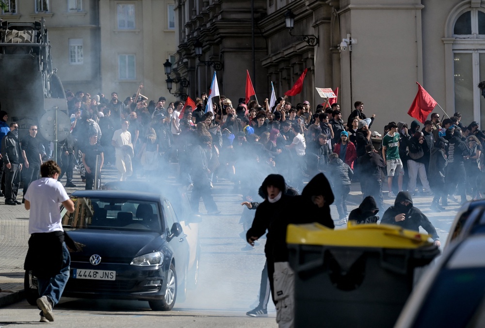 Protesters react to teargas as they take part in a demonstration in the city on Wednesday (AFP/Getty)