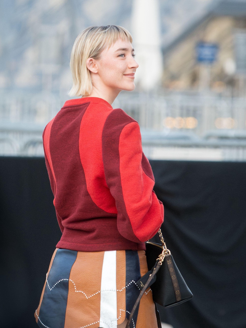Saoirse Ronan, wearing poppy red red at the Louis Vuitton show during Paris Fashion Week (Alamy/PA)