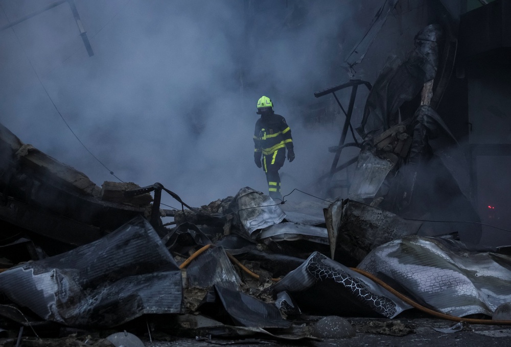 A rescuer works at the site of a shopping centre hit by a Russian missile attack in Kyiv on Thursday (Reuters)
