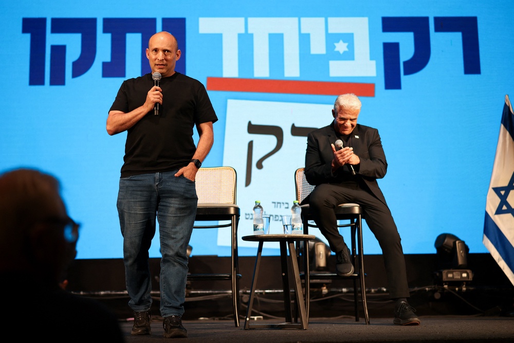 Former prime ministers Naftali Bennett (left) and Yair Lapid attend an event for their B'Yachad party (Reuters)