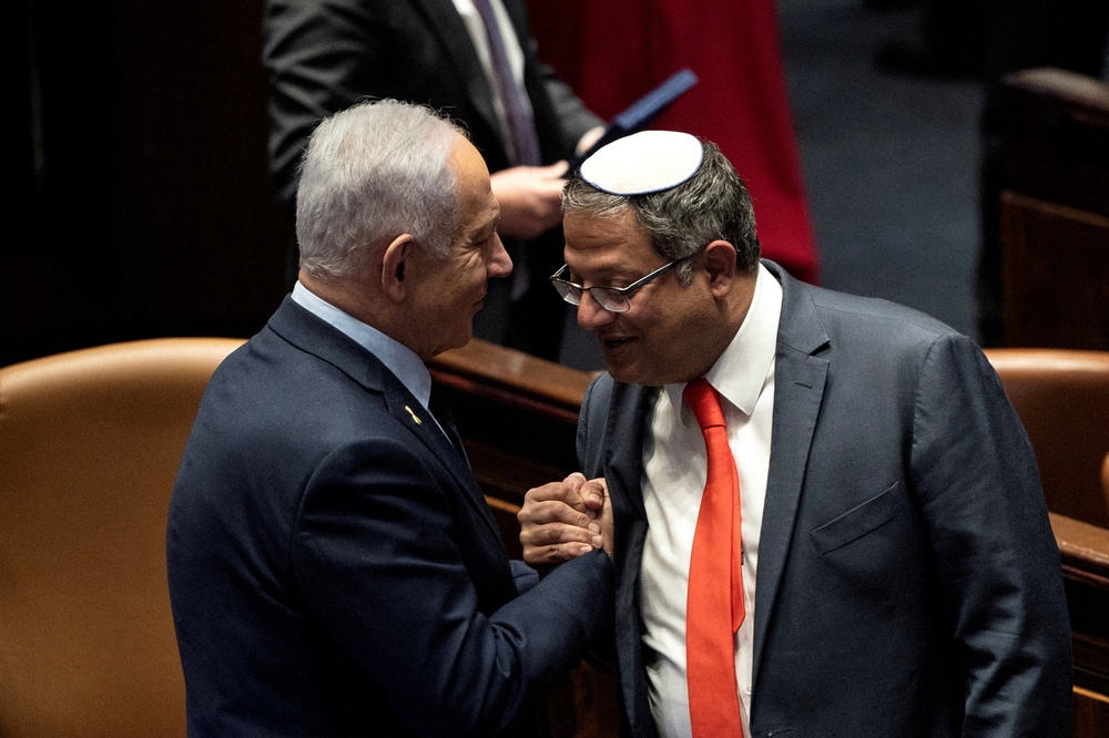 Netanyahu and Itamar Ben-Gvir shake hands in the Knesset last year (Reuters)