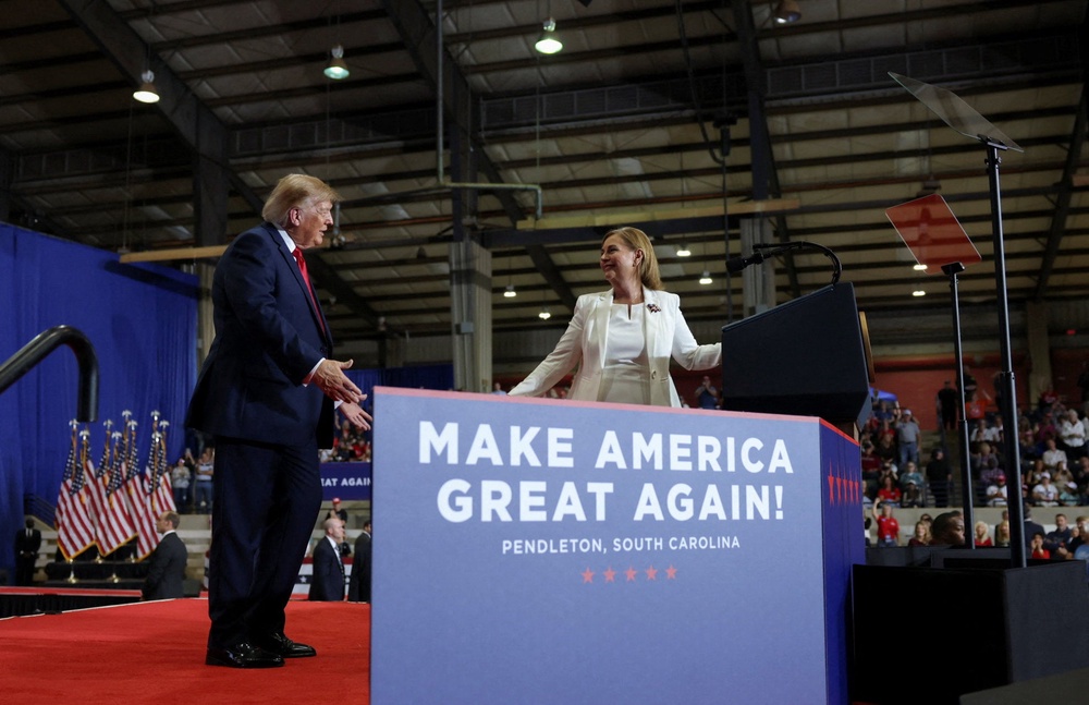 Trump shares the stage with Republican Senate candidate Darline Graham during a rally ahead of the midterms, at T. Ed Garrison Arena at Clemson University in Pendleton, South Carolina (Reuters)
