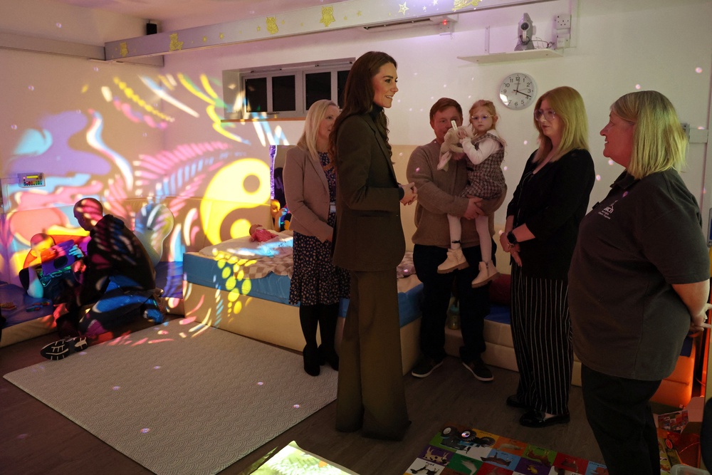 Princess of Wales, speaks with family members inside a light sensory room at The Treehouse children's hospice during a visit to learn about the care and support provided by East Anglia's Children's Hospices (EACH), in Ipswich (Getty)