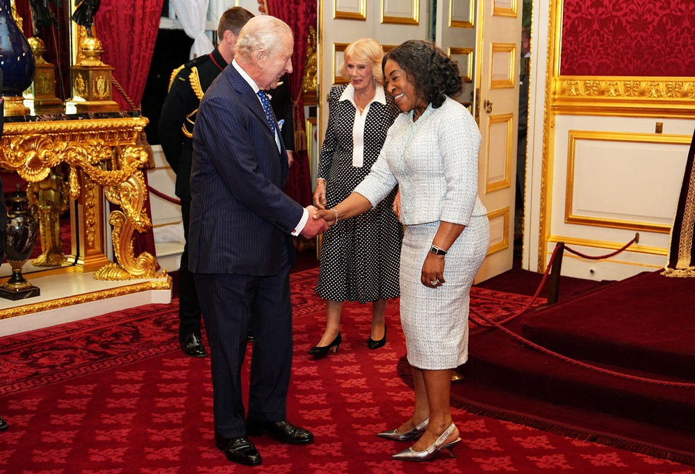 King Charles III and Queen Camilla speak to Shirley Botchwey, Commonwealth Secretary-General, during a reception at St. James's Palace in London, to celebrate the Commonwealth Diaspora, ahead of the Commonwealth Heads of Government Meeting in Antigua and Barbuda, October 14, 2026. (Reuters)