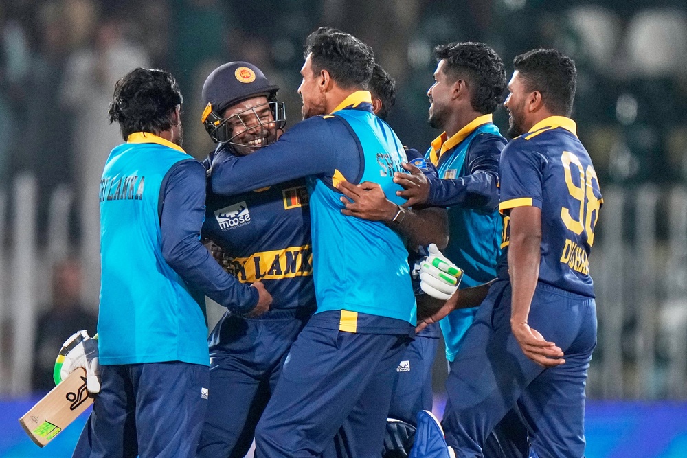 Janith Liyanage, second left, takes the congratulations after Sri Lanka’s stunning win (Anjum Naveed/PA) (AP)