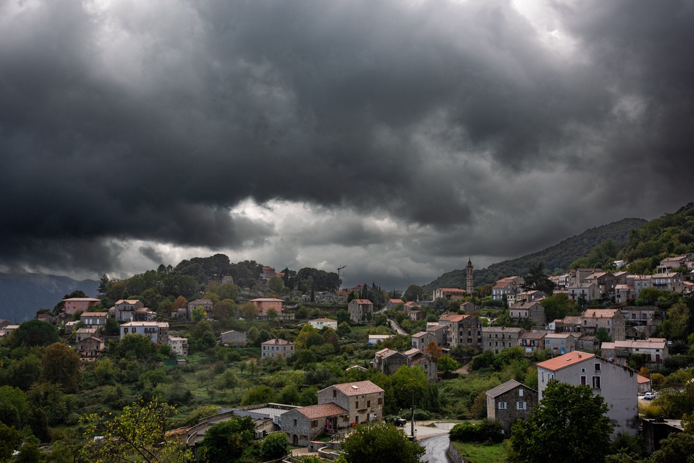 Dark storm clouds gather over the village of Levie as unsettled weather continues across South Corsica in Levie South Corsica France on 21 October 2026 (AFP/Getty)