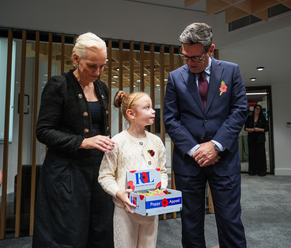 Prime Minister Andy Burnham and his wife Marie France Van Heel speak to Ivy Knighton-Leake, six, one of the UK’s youngest collectors, at No 10 North in Manchester (Christopher Furlong/PA) (PA Wire)