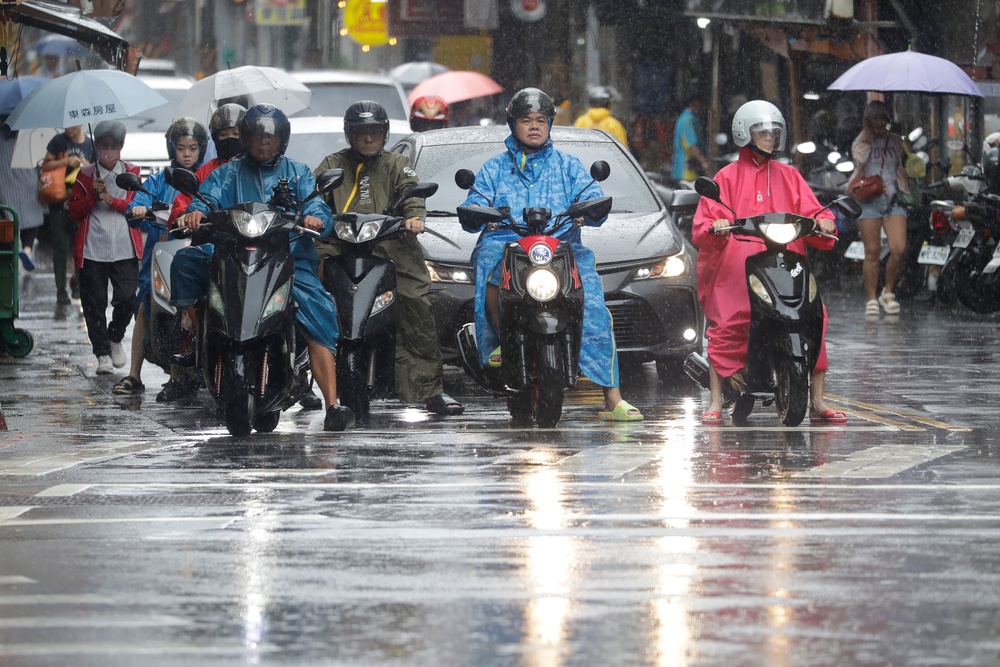 People ride scooters as Typhoon Champi approaches in Taipei, Taiwan, Friday, 23 October 2026 (AP)