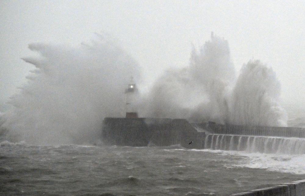 Waves crash over Newhaven Lighthouse and the breakwater in Newhaven (AFP/Getty)