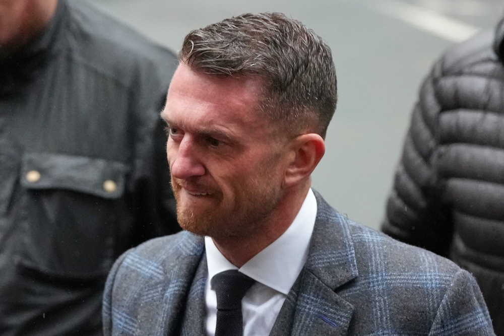Tommy Robinson, who previously gave his name to the court as Stephen Lennon, is accused of harassing editor Jacob Dirnhuber and freelance journalist Andrew Young, causing them fear of violence, in August 2024 (AP)