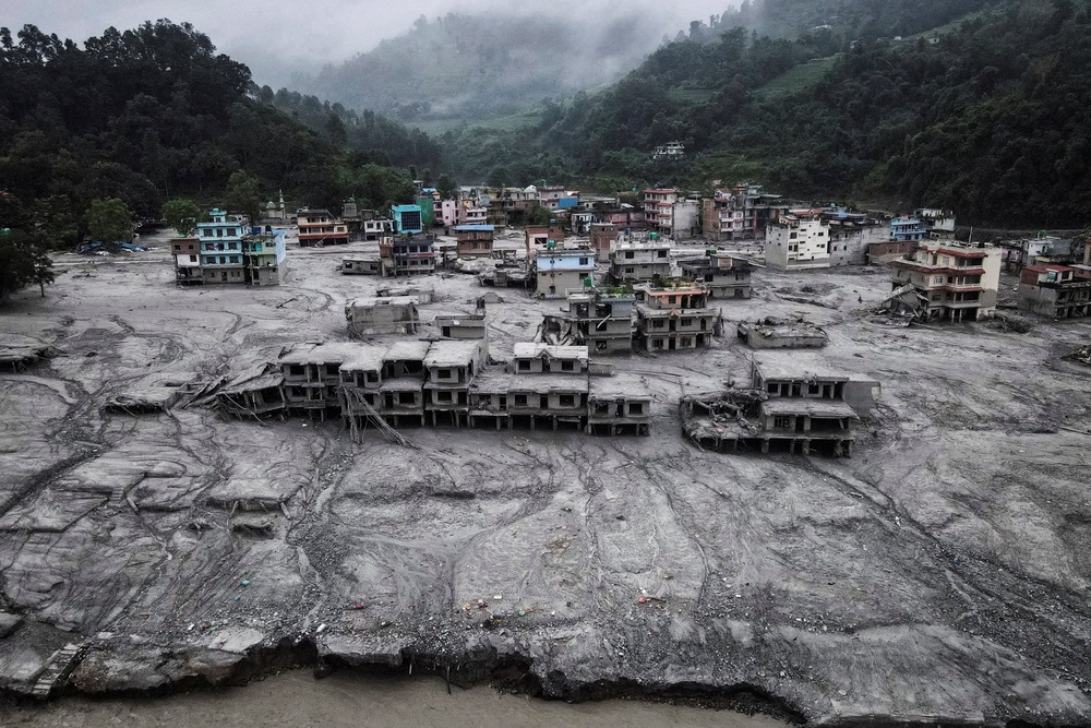 A drone view shows houses covered in mud after the flash floods and mudslide, at Devighat, Nuwakot district, Nepal (Reuters)