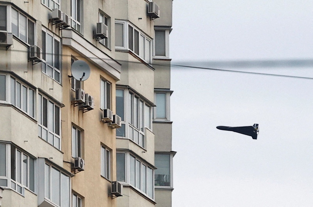 A Russian Geran 2 kamikaze drone flies near a building in Ukraine (Reuters)