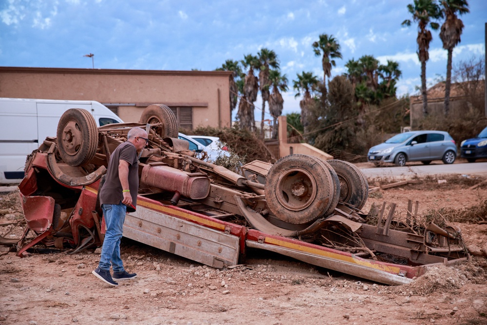 A man inspects an overturned truck after a tornado struck Marsala, a city on Sicily's west coast (Reuters)