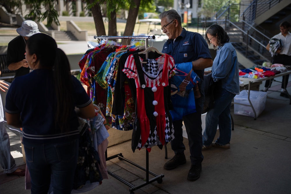 Samuel Hernandez, center, looks for a costume for his grandson (AP)