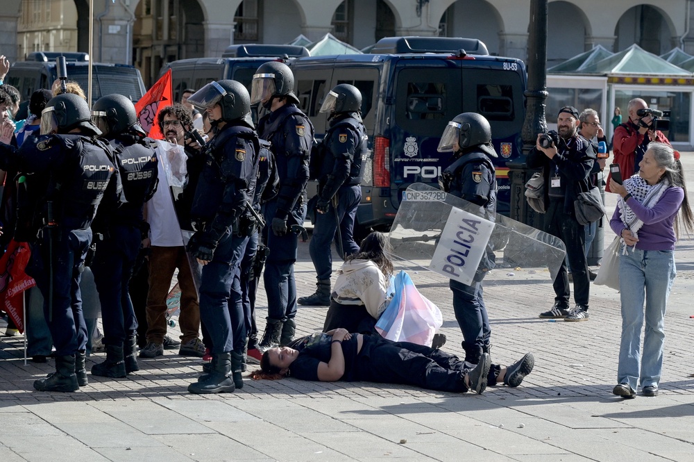 Protesters lay on the ground next to police forces during a demonstration against far-right in A Coruña (AFP/Getty)
