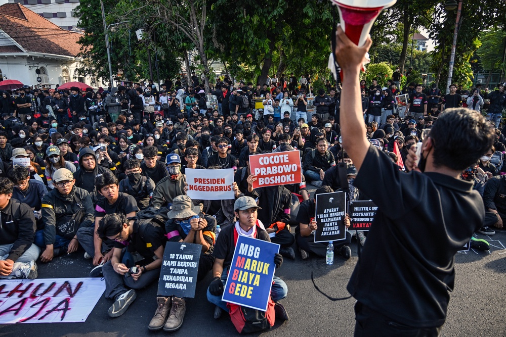 University students sit on a road during an anti-government protest a few days after the second anniversary of President Prabowo Subianto's inauguration in Surabaya (AFP/Getty)