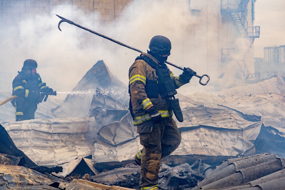 Rescuers working on the roof of a damaged building following Russia’s air attack in Kharkiv, Ukraine, on Friday (AP Photo/Andrii Marienko) (AP)