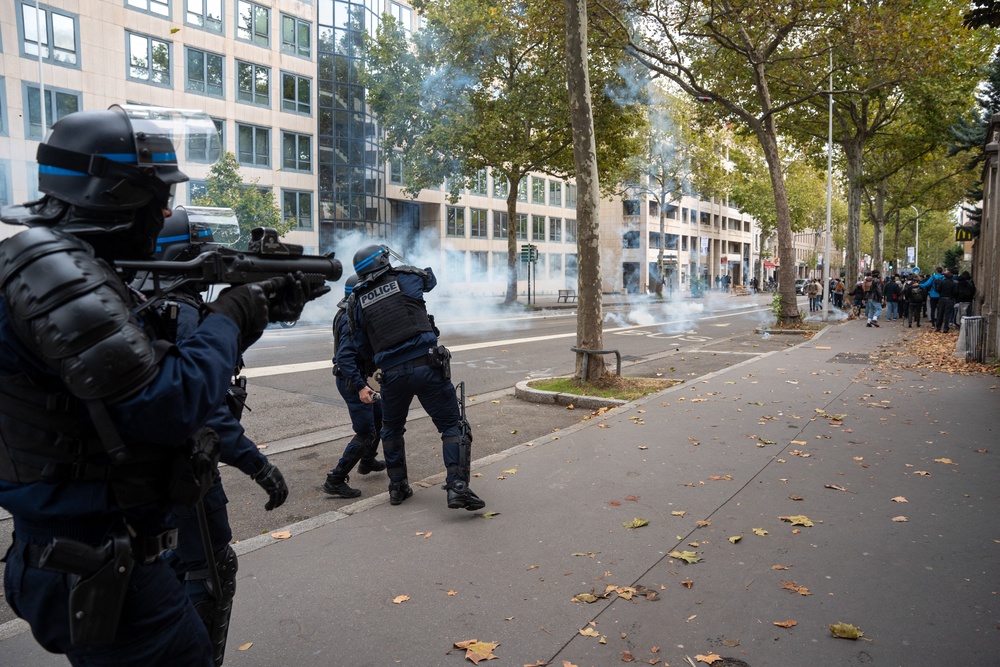 CRS officers a division of the National Police fired a tear gas grenade during a demonstration consisting largely of students in front of the tobacco factory in Lyon, France (AFP/Getty)
