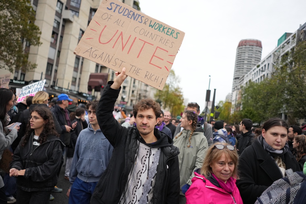 Protesters take part in a demonstration against rising living costs in Paris (AP)