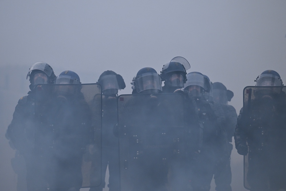 French gendarmes stand amidst tear gas during a demonstration in Nantes (AFP/Getty)