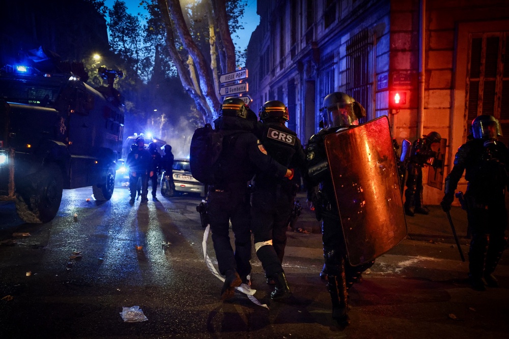 An injured French Republican Security Corps (CRS - Compagnies Republicaines de Securite) police officer is helped by colleagues during a demonstration in favor of purchasing power, the protection of public services, and fiscal and social justice, in Marseille, southeastern France on October 24, 2026 as part of a nationwide call for mobilisation bringing together former members of the Yellow Vest movement, labor unions, high school and university students. (AFP via Getty Images)