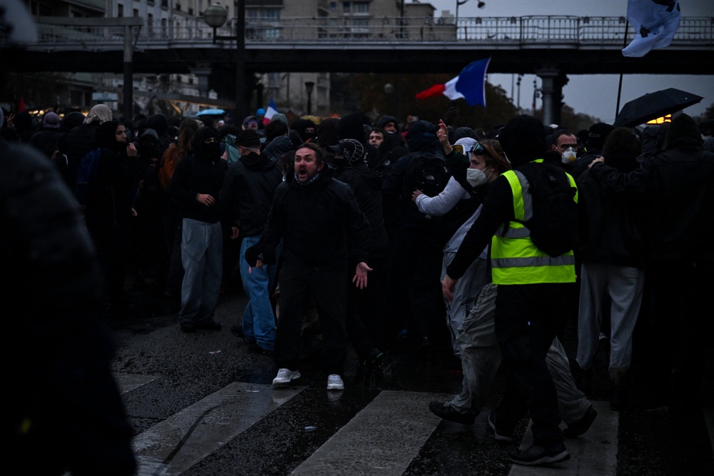 A protester reacts as he faces police officers near Porte de Vincennes during a demonstration in favor of purchasing power, the protection of public services, and fiscal and social justice, in Paris (AFP via Getty Images)