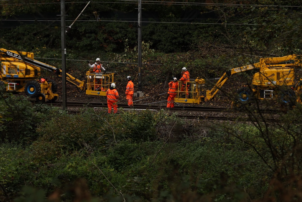 Railway workers are this morning fixing the overhead lines and clearing vegetation in Stansted Mountfitchet, Essex. following strong winds in the area (PA)