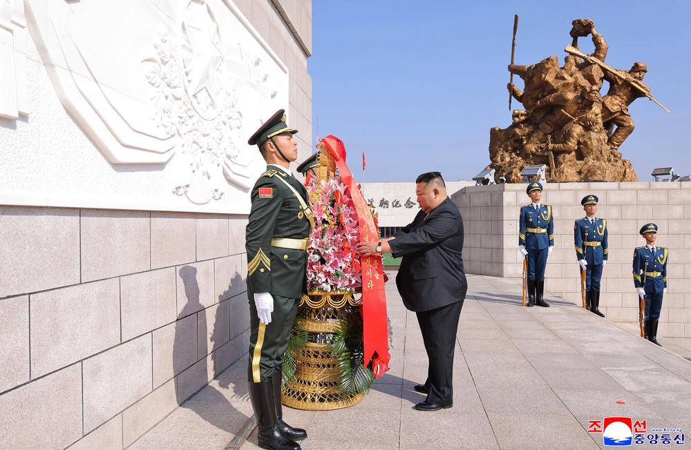 In this photo provided by the North Korean government, its leader Kim Jong Un offers a wreath at a monument in Dandong, China (AP)
