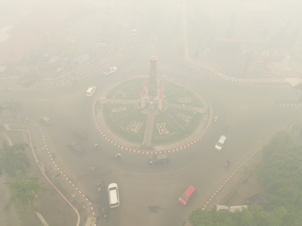 A drone view of vehicles driving along a road near the Zero Point roundabout (Bundaran Titik Nol) as haze from wildfires shrouds the area in East Kotawaringin Regency, Central Kalimantan province, Indonesia (Reuters)