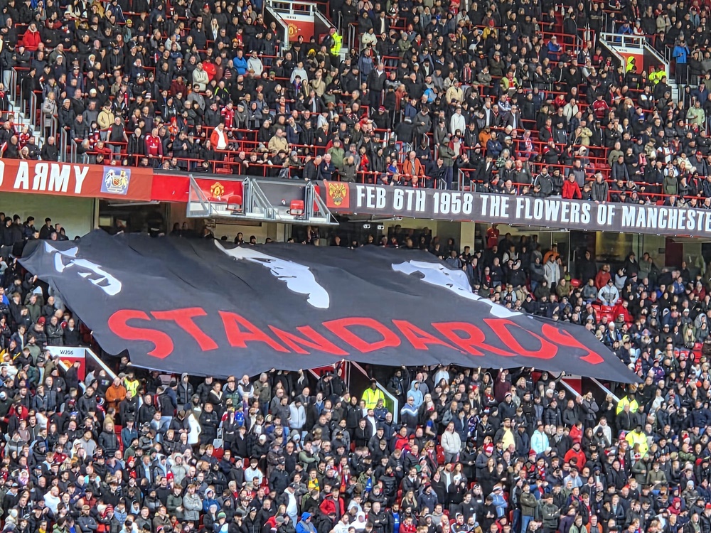 Man United fans unveil a banner (Richard Jolly / The Independent)
